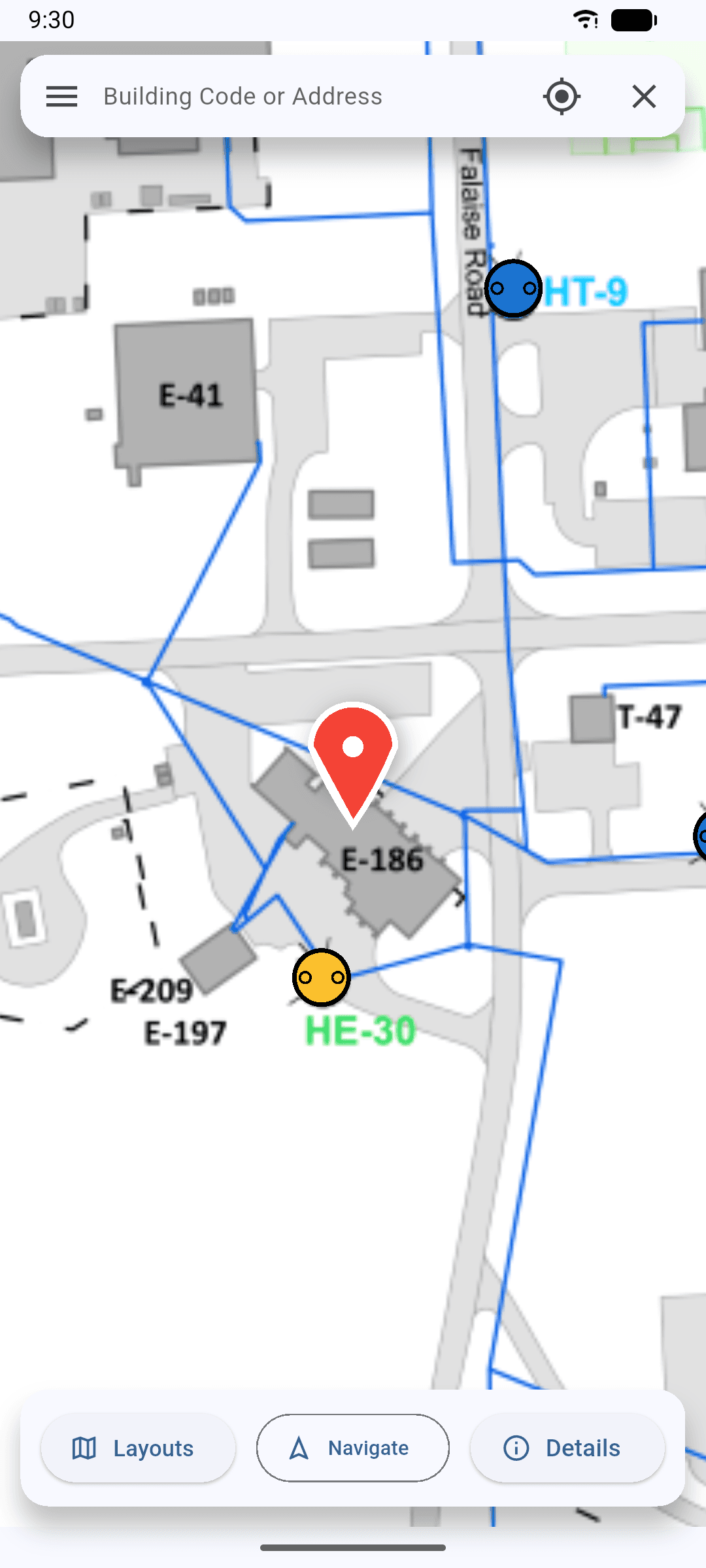 The selected building highlighted by a red pin on the phone map.